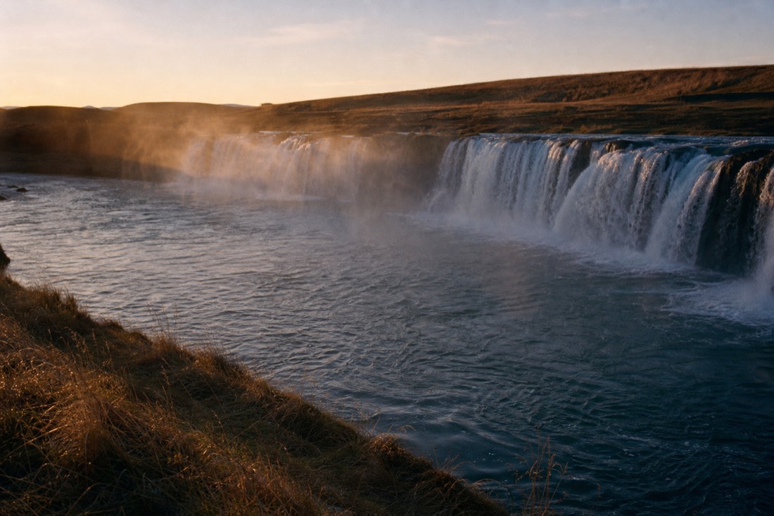 Low golden morning light on the wide Faxi waterfall with no visitors yet