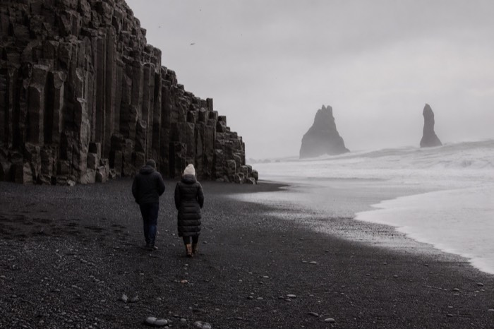 Reynisfjara black sand beach with basalt columns and crashing surf on Iceland's south coast